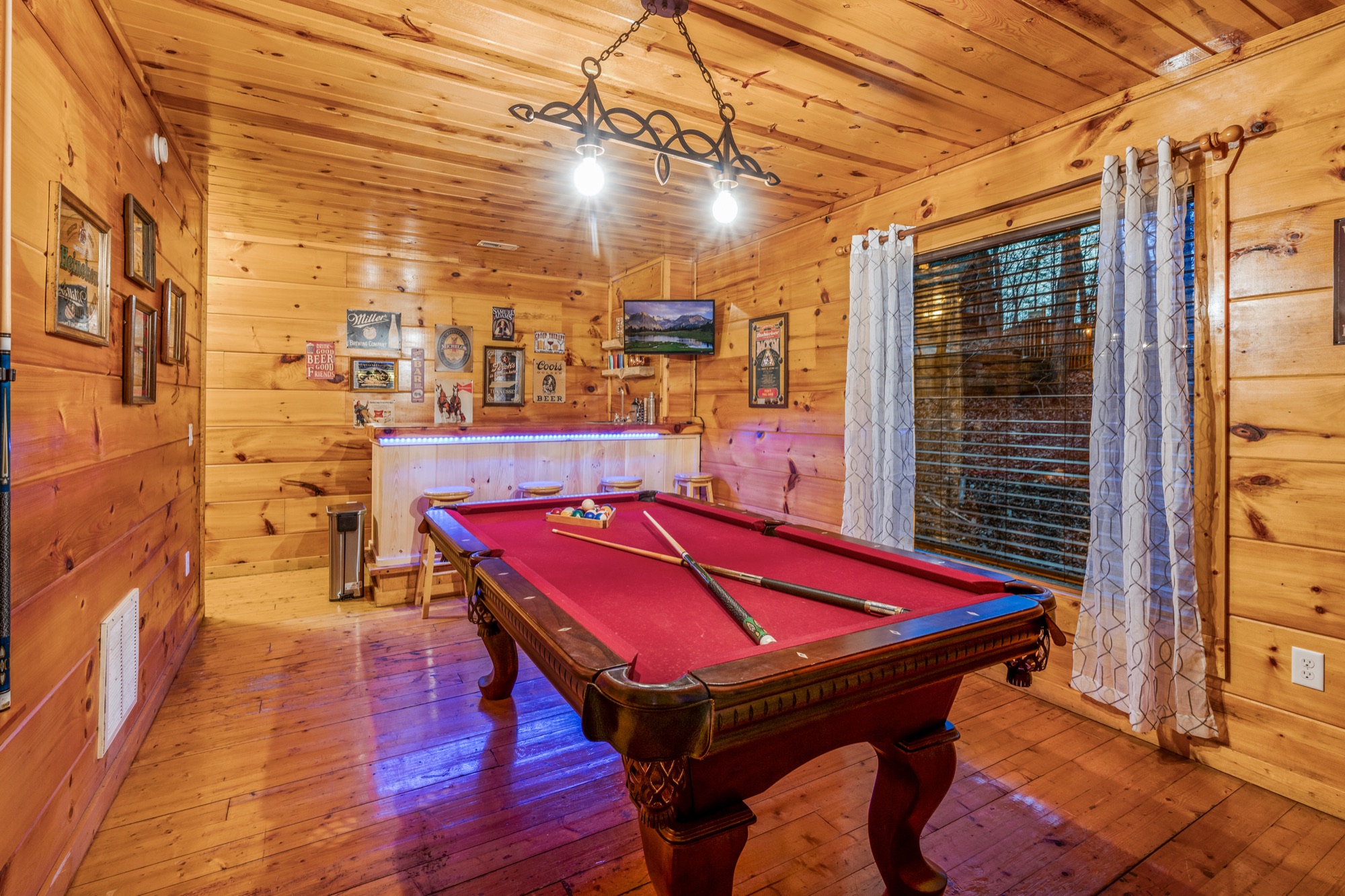 Wide view of Bearadise's game room with the pool table and full wet bar